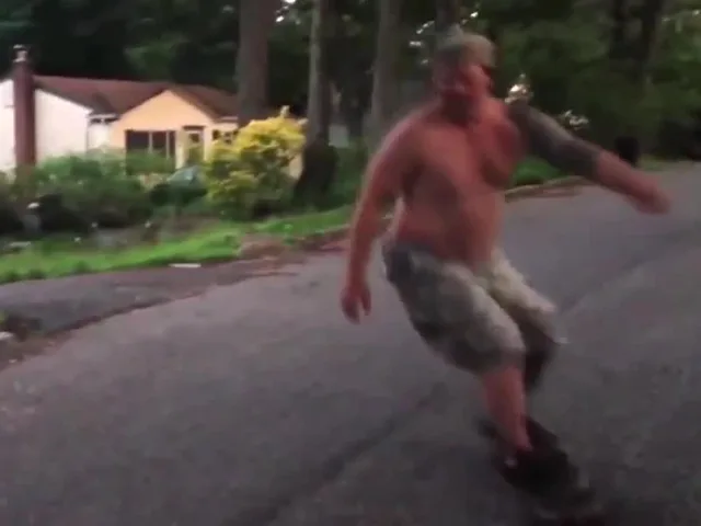 Founding rider skateboarding down a neighborhood street on a prosthetic leg
